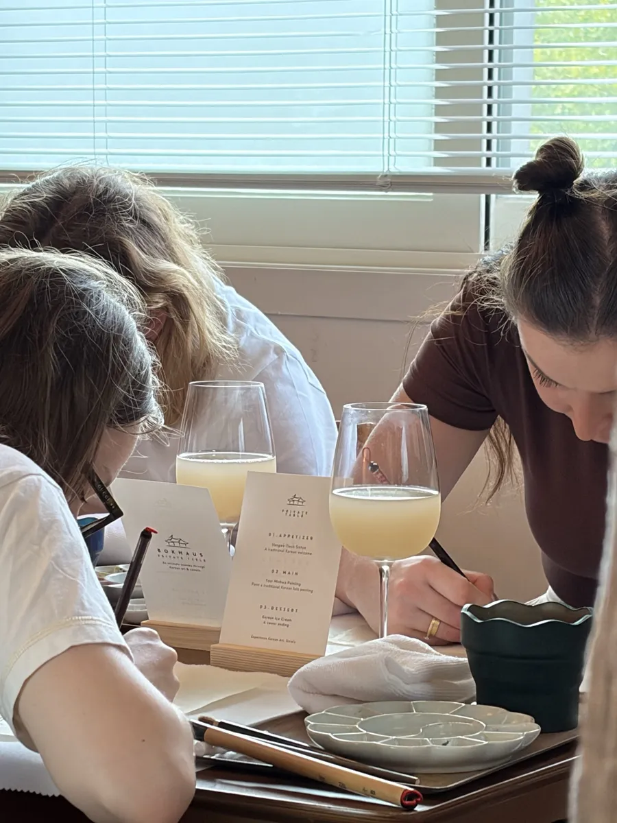 Guests painting, a printed menu card in the foreground